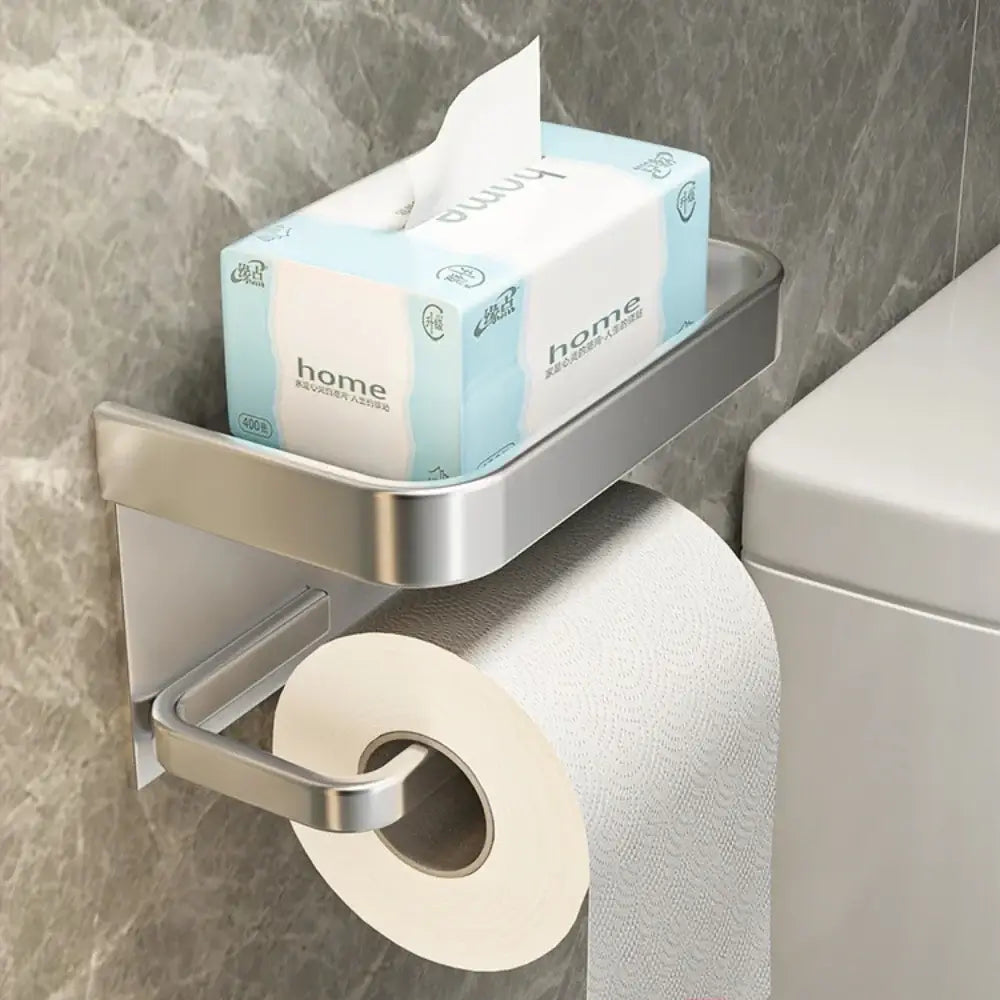 Silver Toilet Paper Roll Holder Phone Shelf with tissue box on top, mounted on bathroom wall for modern storage.