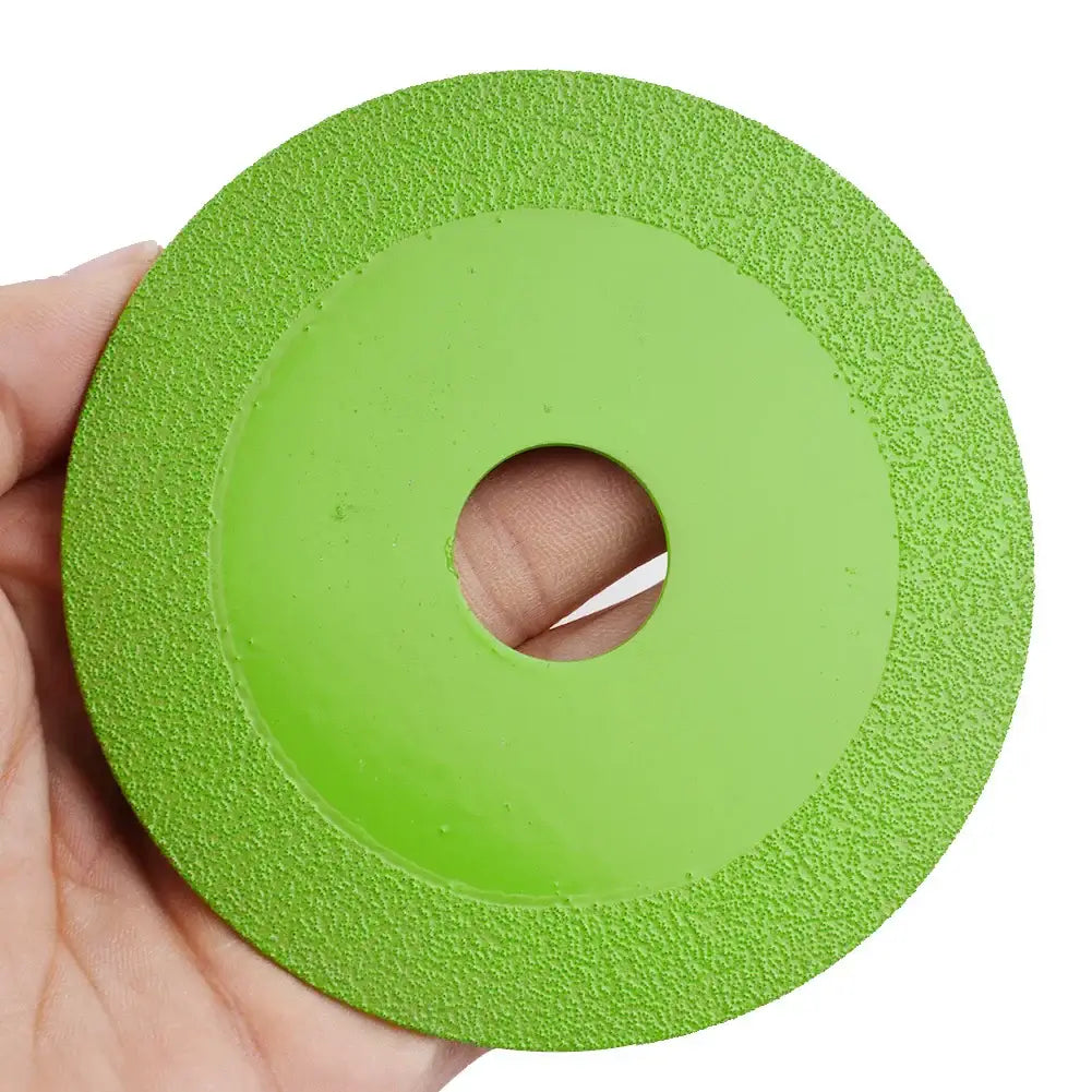 Bright green diamond cutting blade for precise tile and glass cutting, held by hand.